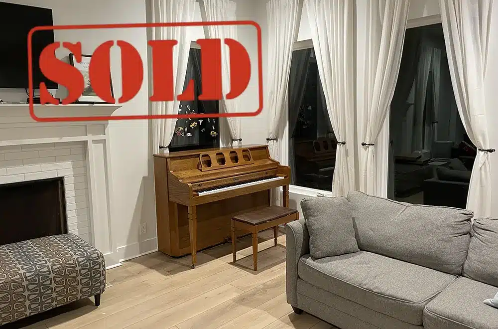 kimball-console-sold piano in a room